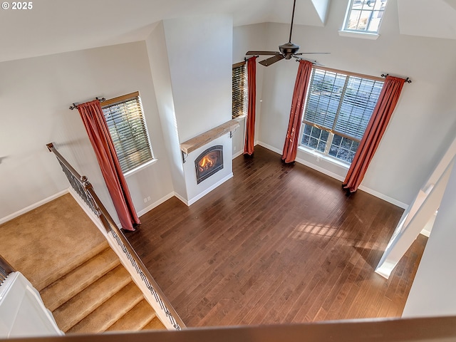 living room featuring dark hardwood / wood-style flooring and ceiling fan