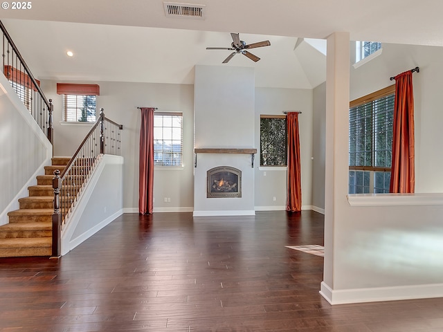 unfurnished living room featuring dark wood-type flooring, high vaulted ceiling, and ceiling fan