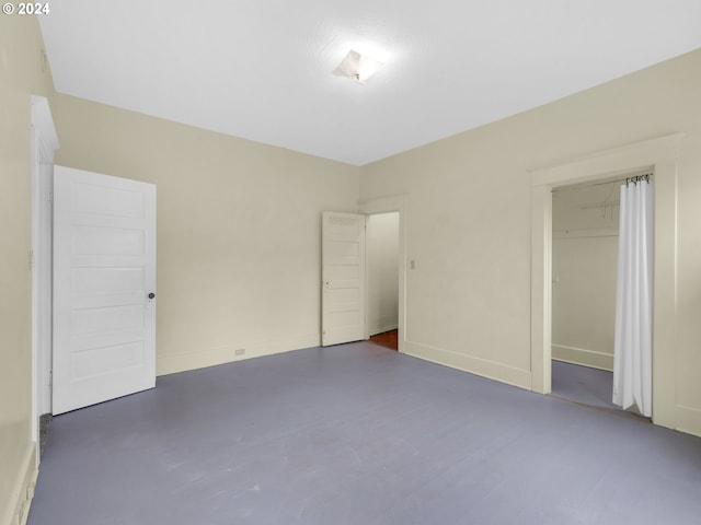 unfurnished bedroom featuring a closet and concrete floors