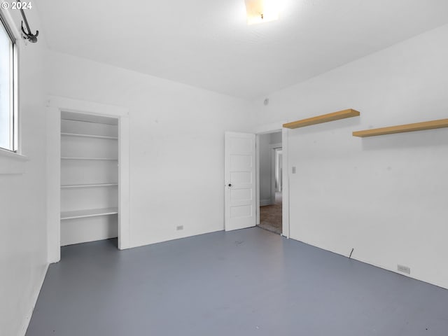 spare room with concrete flooring