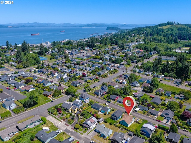 drone / aerial view featuring a water and mountain view