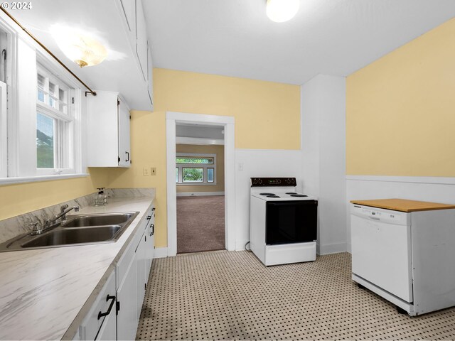 kitchen featuring white cabinets, white appliances, light tile patterned flooring, and sink