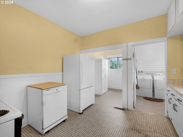 kitchen featuring white cabinetry, white appliances, washing machine and clothes dryer, and light tile patterned flooring