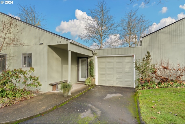 exterior space with a garage and a front lawn