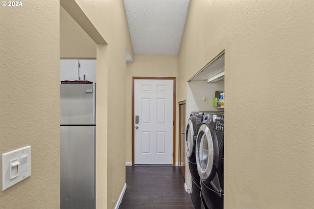 laundry room featuring dark wood-type flooring, separate washer and dryer, and a textured ceiling