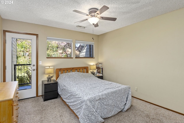 bedroom with access to exterior, ceiling fan, light carpet, and a textured ceiling