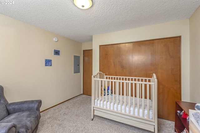 carpeted bedroom with electric panel and a textured ceiling