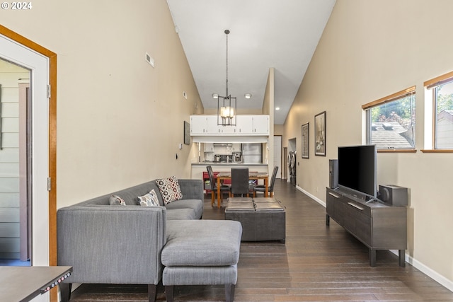 living room with a chandelier, dark hardwood / wood-style flooring, and high vaulted ceiling