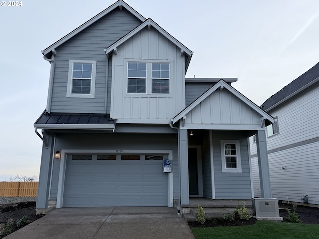 view of front of home with ac unit and a garage