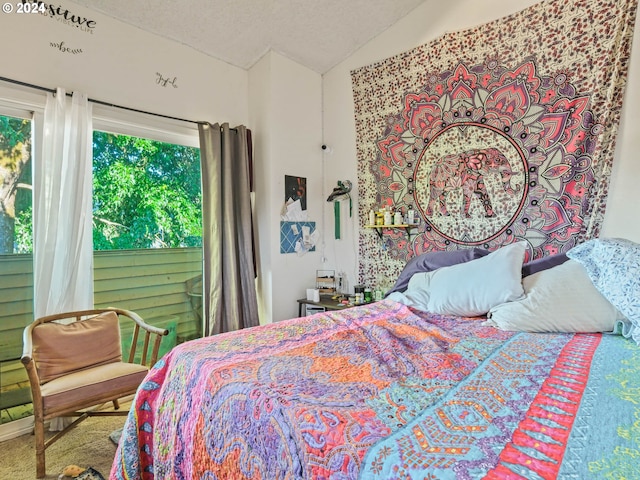 carpeted bedroom with vaulted ceiling and a textured ceiling