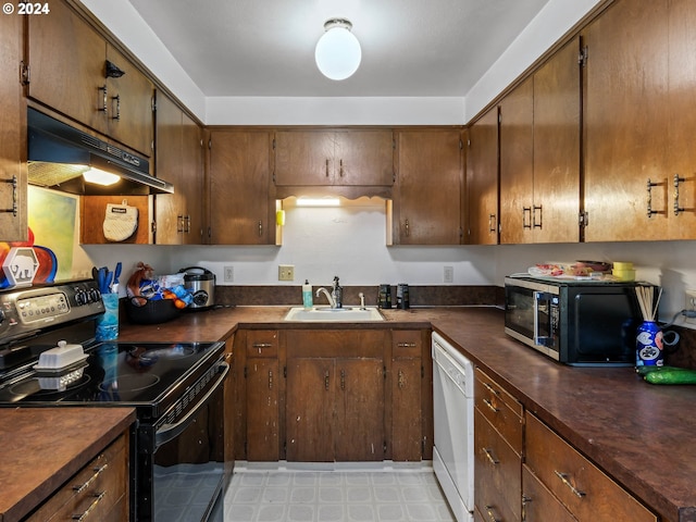 kitchen with white dishwasher, sink, black range with electric cooktop, and light tile floors