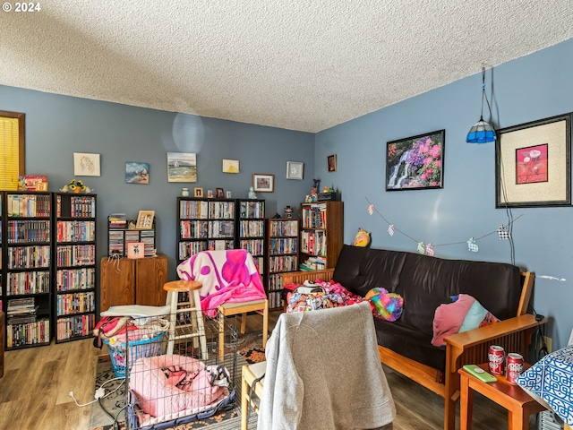 living room with a textured ceiling and wood-type flooring