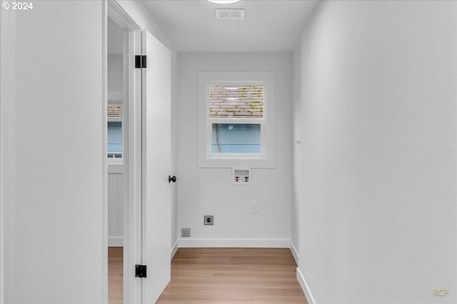 clothes washing area featuring hookup for an electric dryer, washer hookup, and light hardwood / wood-style floors