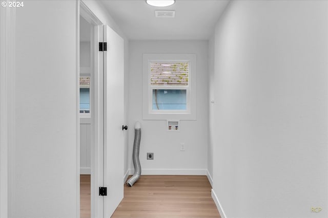 clothes washing area featuring washer hookup, light wood-type flooring, and electric dryer hookup