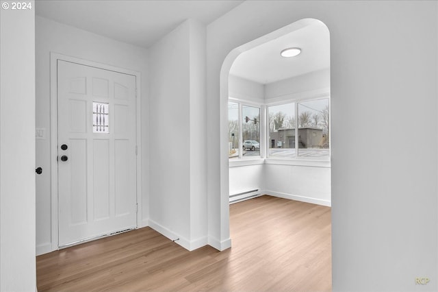 entrance foyer featuring light wood-type flooring and baseboard heating