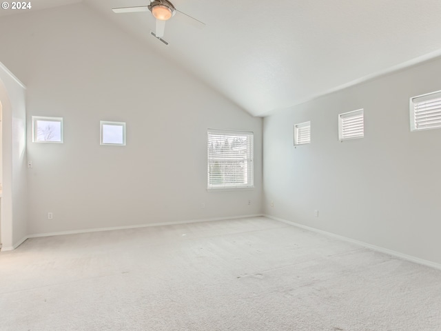 spare room with ceiling fan, light carpet, and high vaulted ceiling