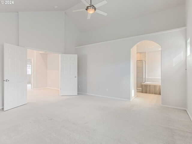 interior space featuring ceiling fan and high vaulted ceiling