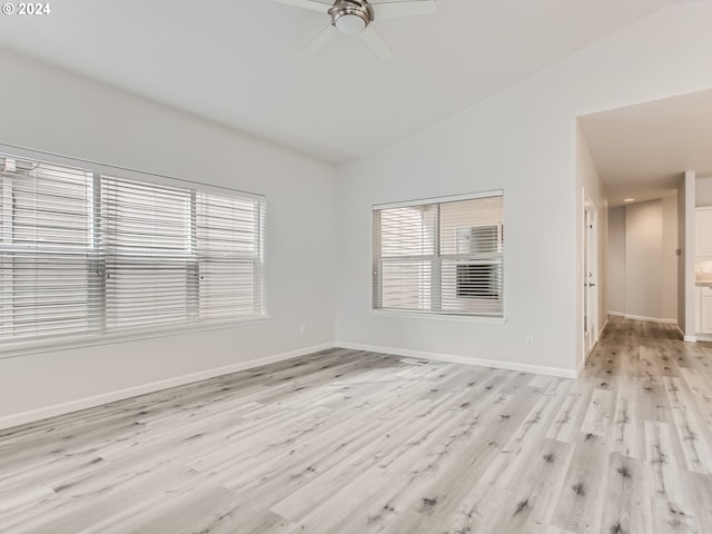 unfurnished living room with ceiling fan, light wood-type flooring, and lofted ceiling