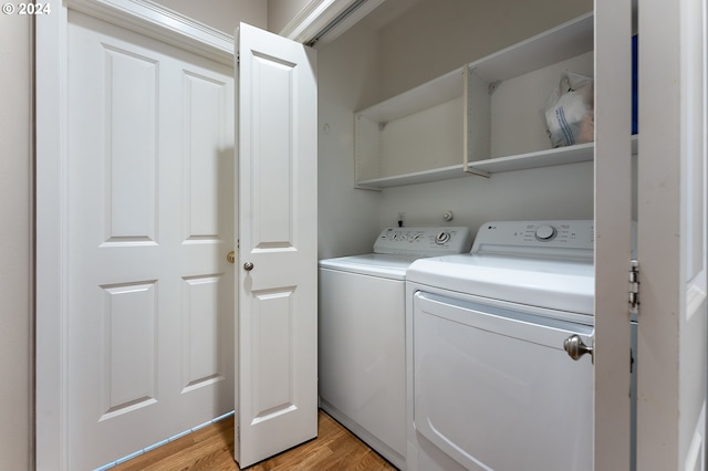 washroom featuring washer and dryer and light hardwood / wood-style flooring