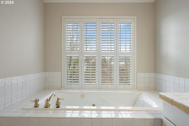 bathroom with plenty of natural light and a relaxing tiled tub