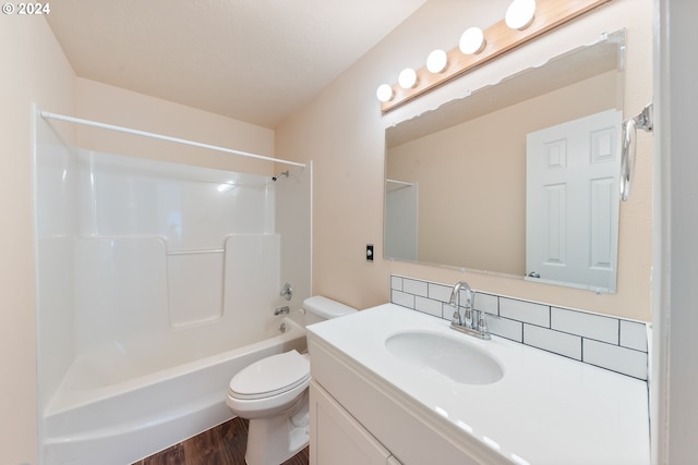 full bathroom with toilet, bathing tub / shower combination, hardwood / wood-style floors, and vanity