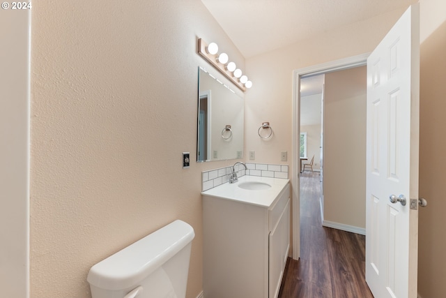 bathroom featuring hardwood / wood-style floors, vanity, and toilet