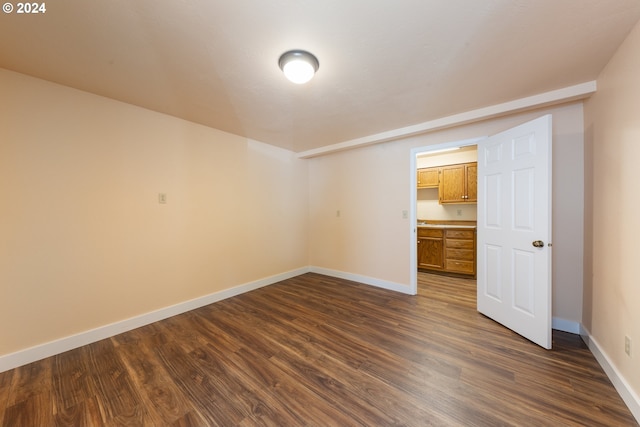 unfurnished bedroom featuring dark hardwood / wood-style floors