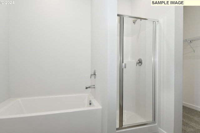 bathroom with separate shower and tub