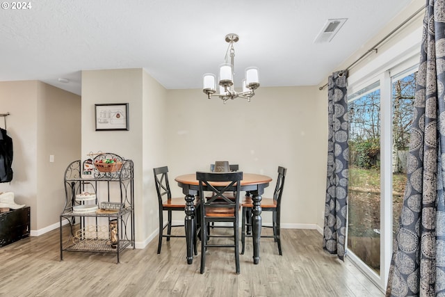 4711 Siesta Ct NE, Salem, OR 97305 - dining area featuring light hardwood / wood-style floors and an inviting chandelier