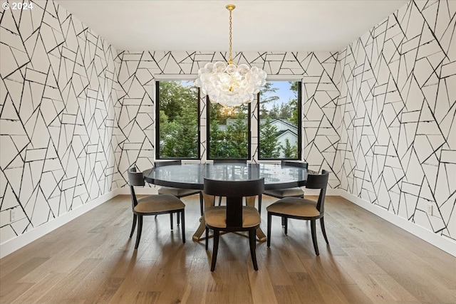 dining room featuring wood-type flooring and a chandelier