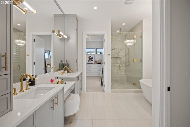 bathroom with plus walk in shower, tile patterned flooring, and vanity