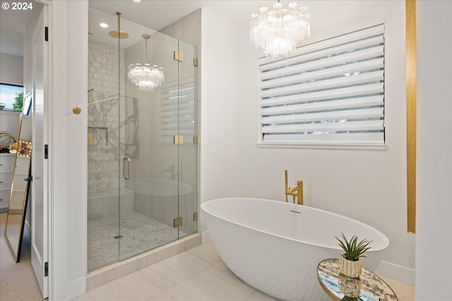 bathroom with tile patterned flooring, an inviting chandelier, and plus walk in shower