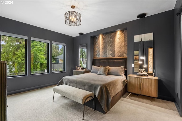 bedroom with light carpet and a chandelier