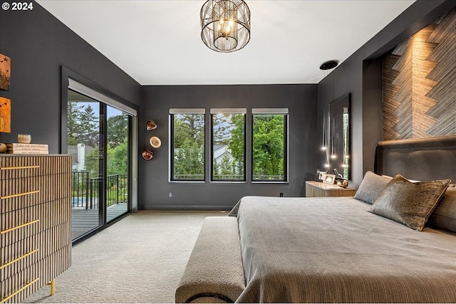 bedroom featuring light colored carpet, a chandelier, and access to exterior