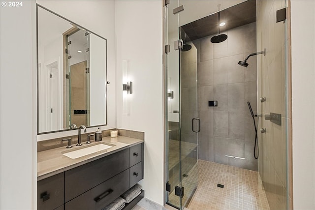 bathroom with vanity, tile patterned floors, and a shower with door