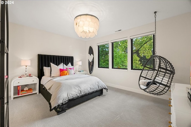 bedroom with an inviting chandelier and carpet flooring