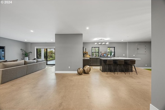 kitchen featuring an inviting chandelier, pendant lighting, a kitchen island, and a breakfast bar area