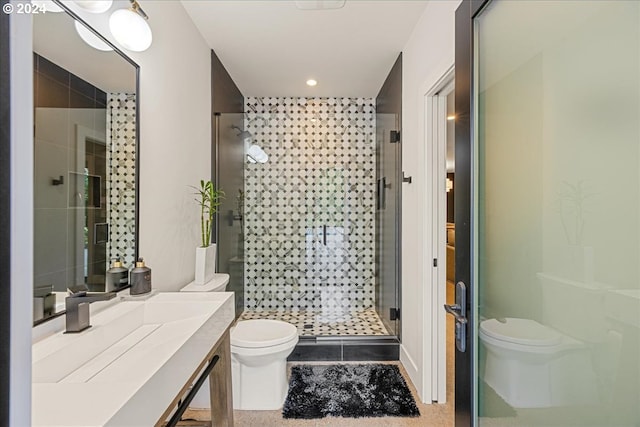 bathroom with vanity, toilet, a shower with door, and tile patterned floors