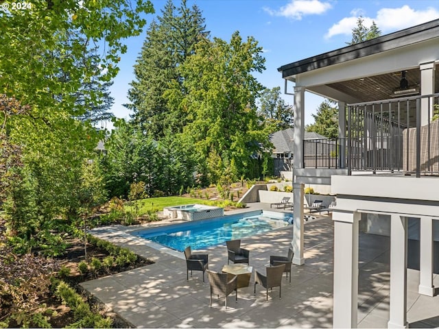 view of swimming pool featuring a patio and ceiling fan