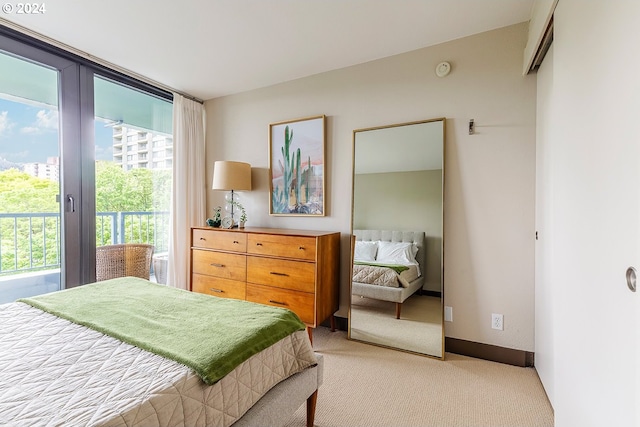 carpeted bedroom featuring access to outside and multiple windows