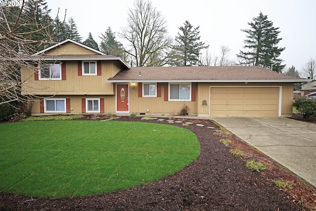 tri-level home with a garage and a front lawn