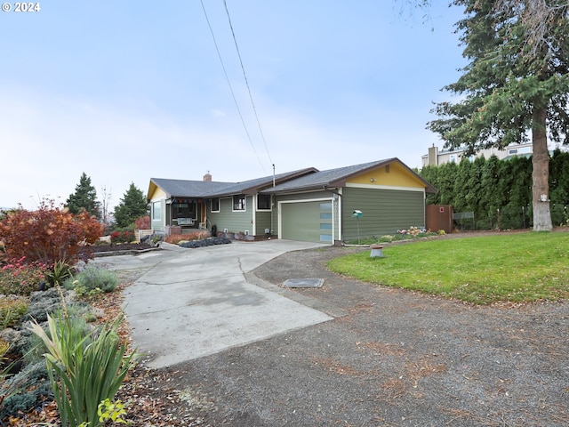 ranch-style house with a garage and a front yard