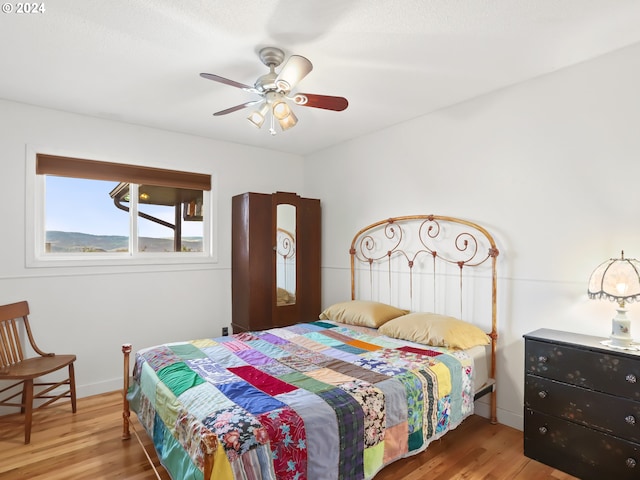 bedroom featuring ceiling fan and hardwood / wood-style floors