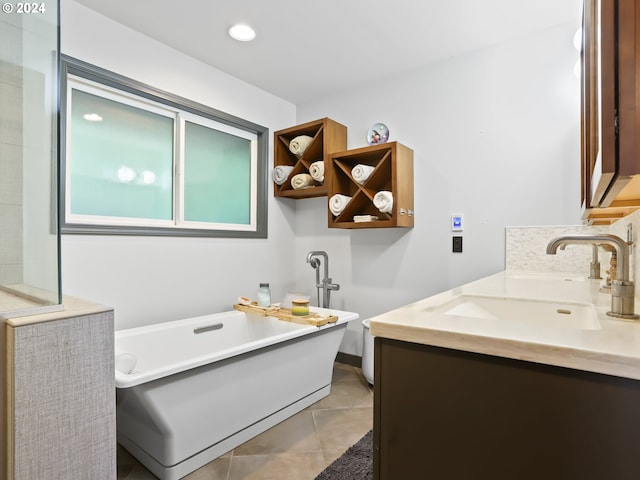 bathroom with tile patterned floors, vanity, and a tub