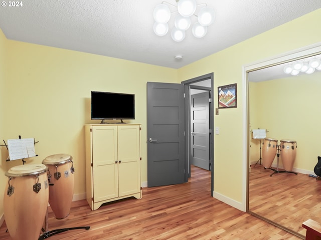 interior space with light hardwood / wood-style flooring and a textured ceiling