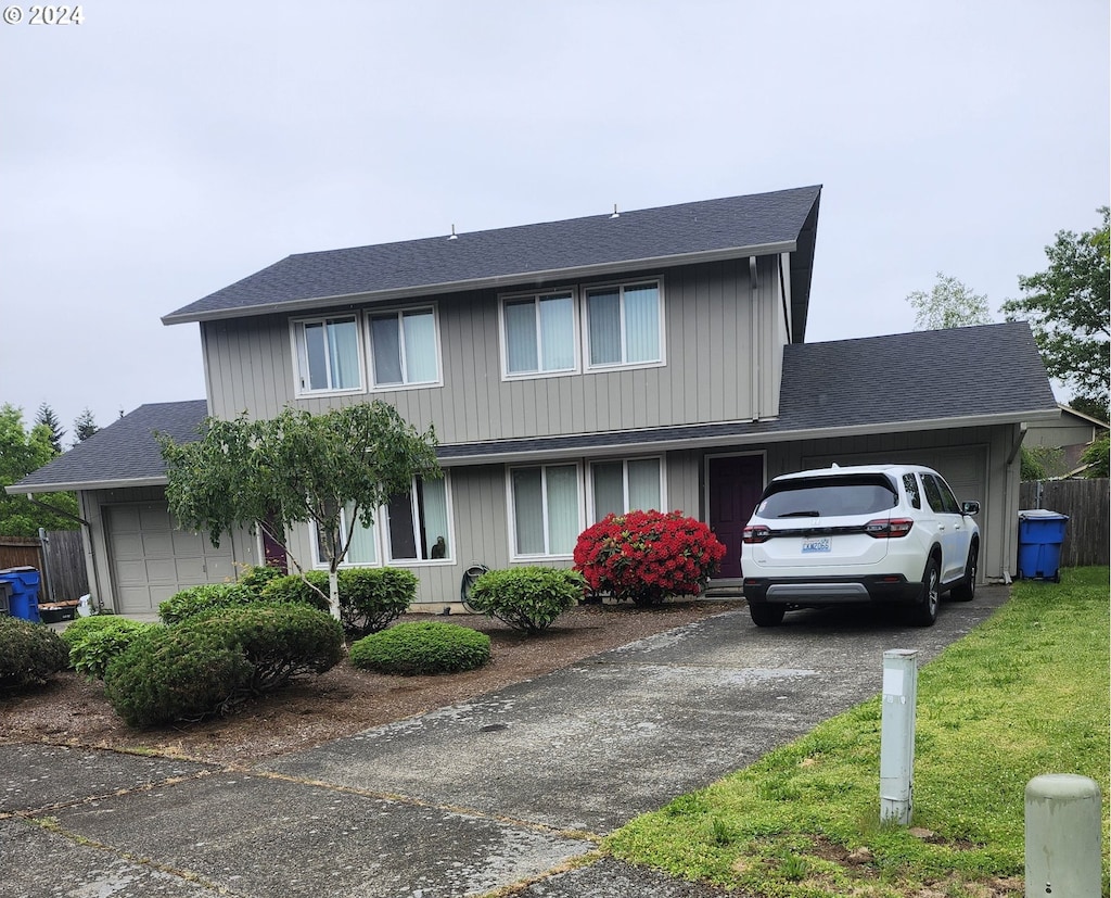 view of front property with a garage and a front yard