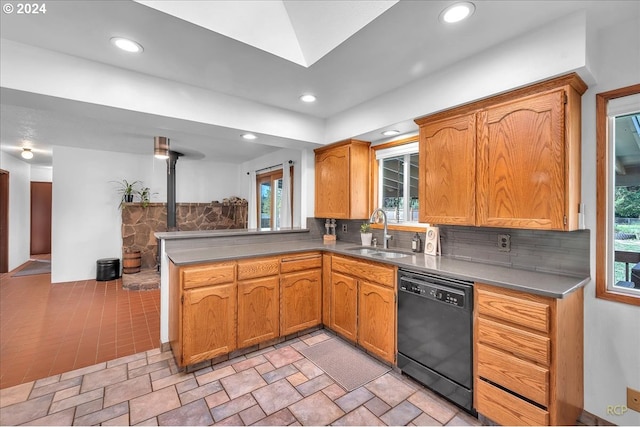 kitchen with black dishwasher, backsplash, sink, and a healthy amount of sunlight