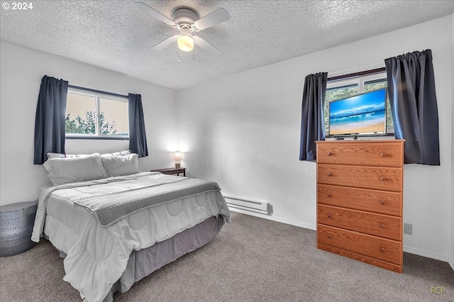 carpeted bedroom featuring ceiling fan, a textured ceiling, and a baseboard heating unit