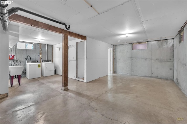 basement with independent washer and dryer and sink