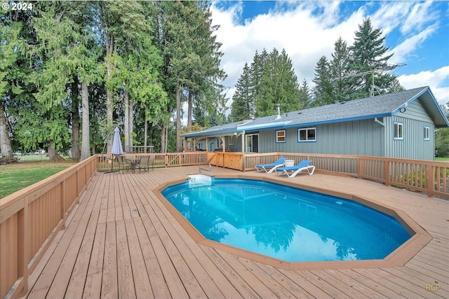 view of swimming pool featuring a wooden deck